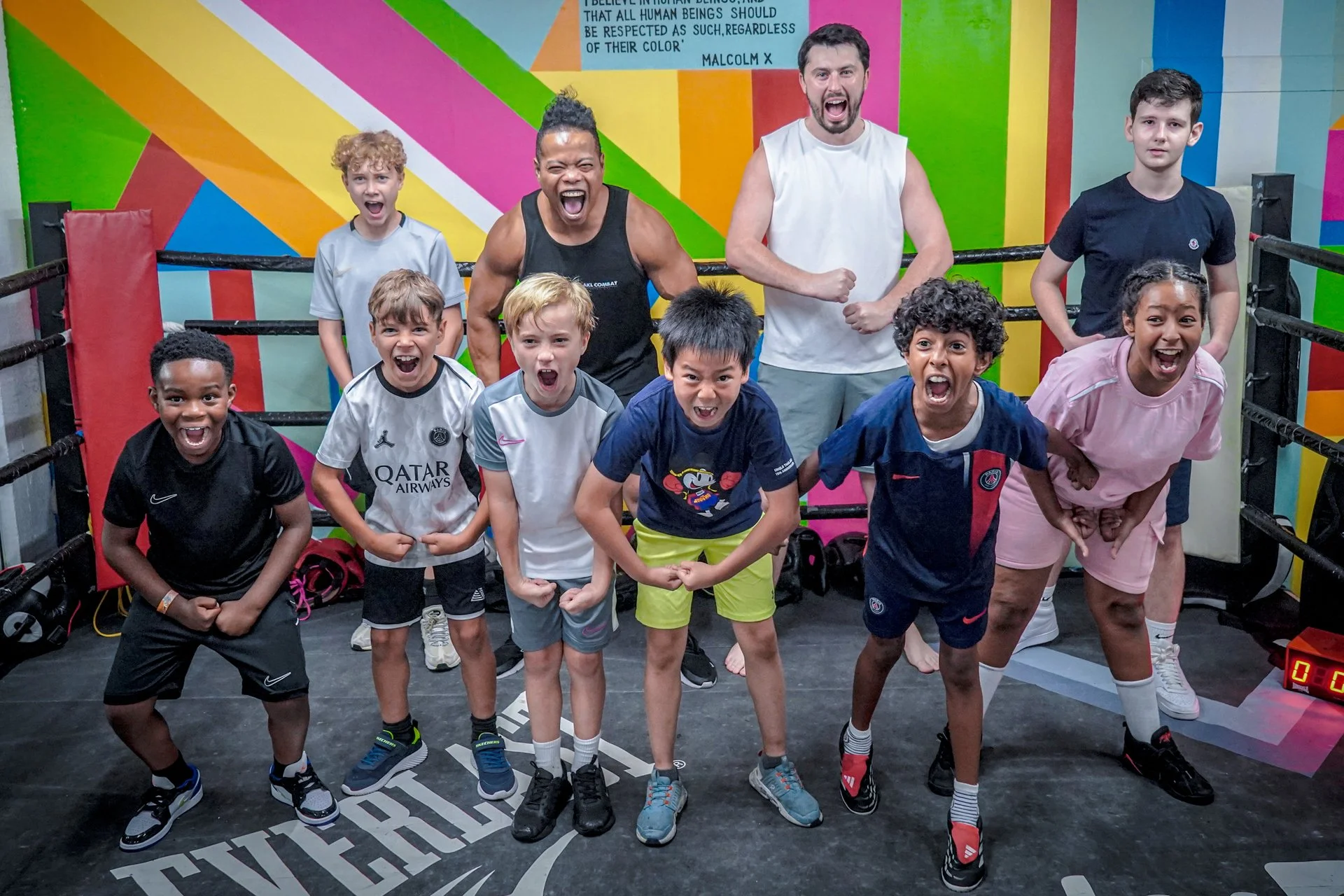 Young participants training together on the mats